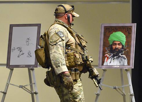 Member of US special forces in front of drawings of Prophet Mohammad at event where shooting took place. (Photo: EPA) (Photo: EPA)