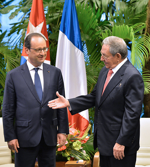 נשיא קובה ראול קסטרו מושיט את ידו לנשיא צרפת פרנסואה הולנד, שהגיע לביקור בהוואנה. הולנד קרא להסרת האמברגו האמריקני מעל האי הקריבי במהלך ביקורו הראשון של מנהיג מערבי בקובה מאז שזו חידשה את היחסים עם יריבתה הקומוניסטית (צילום: AFP) (צילום: AFP)