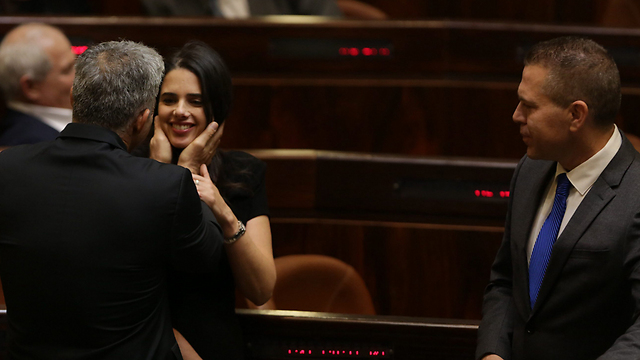 MK Yair Lapid congratulates new Justice Minister Ayelet Shaked. 'A slap in the face with one hand and a friendly slap on the shoulder with the other hand' (Photo: Olivier Fitoussi) 