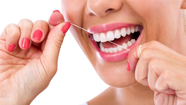 הכי פשוט להיעזר בחוט דנטלי או קיסם כדי לנקות בין השיניים (צילום: shutterstock) (צילום: shutterstock)