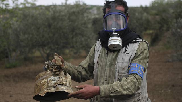A Civil Defense member carries a damaged canister in Ibleen village from what activists said was a chlorine gas attack in early May (Photo: Reuters)
