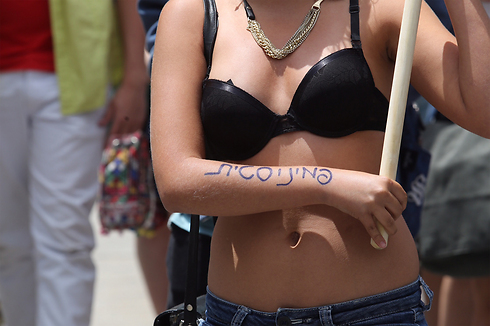 'Feminist' written on arm of participant in SlutWalk in Jerusalem (Photo: Gil Yohanan)