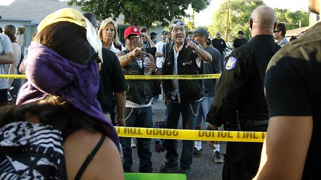 Anti-Islam protesters confronting counterprotesters from beyond police line (Photo: AP)