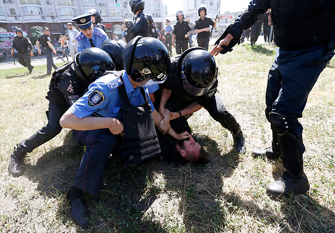 שוטרים עוצרים את אחד מתוקפיהם של הצועדים (צילום: רויטרס) (צילום: רויטרס)
