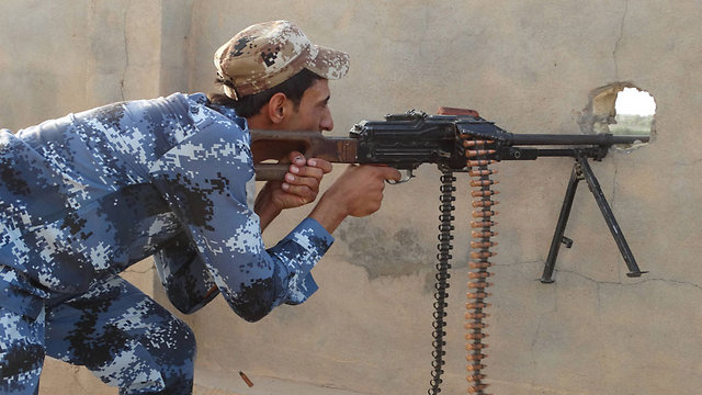 An Iraqi soldier fires at ISIS positions near Ramadi. (Photo: AP) (Photo: AP)