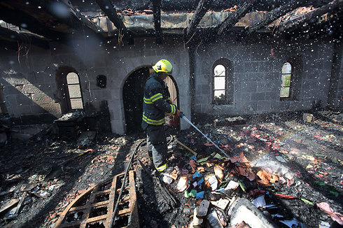 Firefighter at the church (Photo: AFP)
