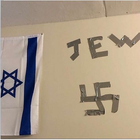 Swastika and the word 'Jew' taped next to student's Israeli flag in Drexel dorm room (Photo: ADL)