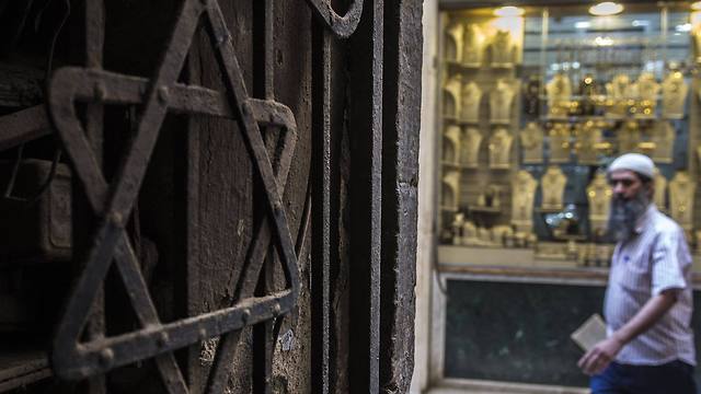 A man walks past a Star of David decorating the door of a home in the Jewish quarter of the Egyptian capital, Cairo (Photo: AFP)