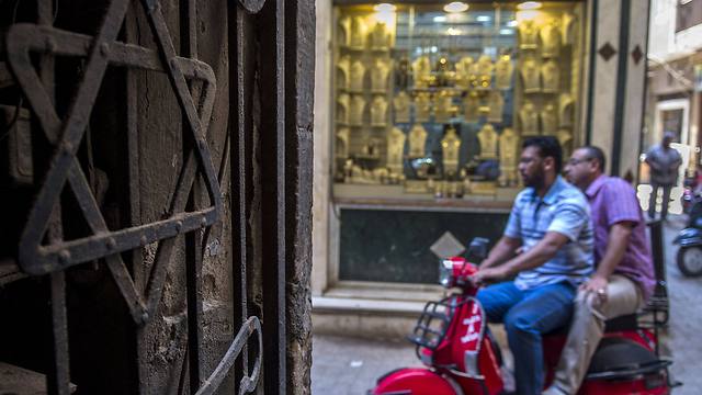 Egyptian men riding a scooter drive past a Star of David decorating the door in Cairo (Photo: AFP) 
