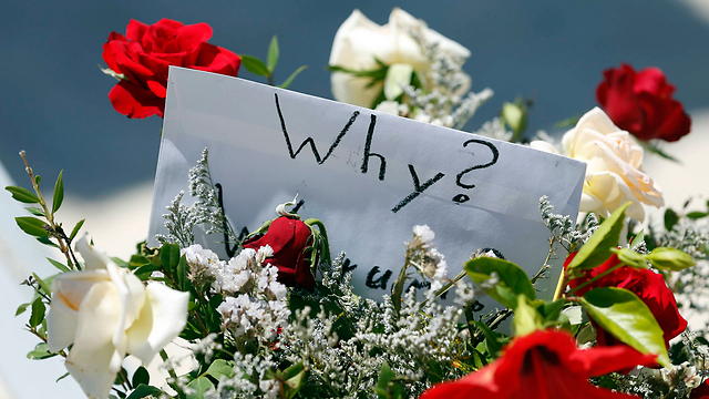 Flowers and a sign left at the scene of the attack. (Photo: AP) (Photo: AP)
