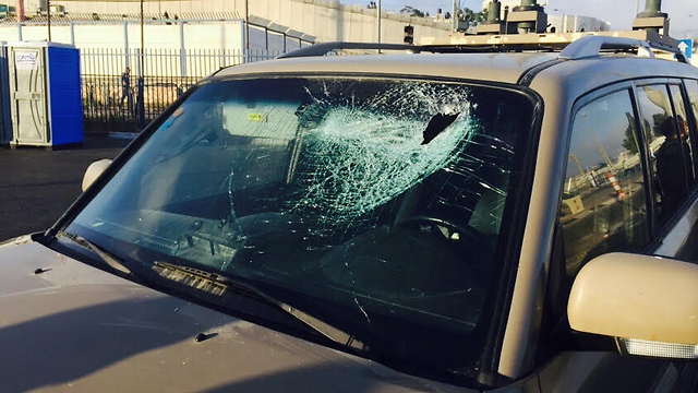 The jeep, damaged by the Palestinian stone throwers.