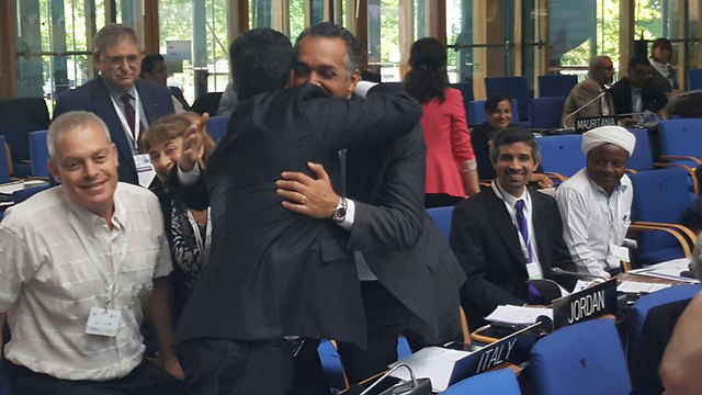 Israel and Jordan's representatives to UNESCO embrace after the declaration of Beit She'arim as a World Heritage Site 