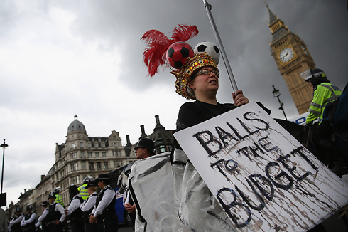 מפגינים מתאספים מחוץ לפרלמנט בלונדון בזמן ששר האוצר הבריטי ג'ורג אוסבורן מגיש את הצעת התקציב, הכוללת קיצוצים בהיקף של מיליונים ברווחה, לאנשי הבית (צילום: gettyimages) (צילום: gettyimages)