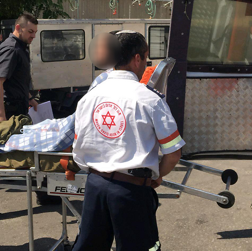The wounded soldier being evacuated by paramedics (Photo: Tazpit)