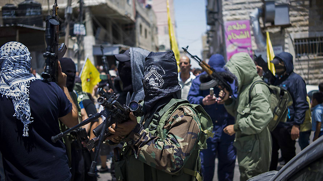 Armed men at Qalandiya checkpoint (Photo: Getty)