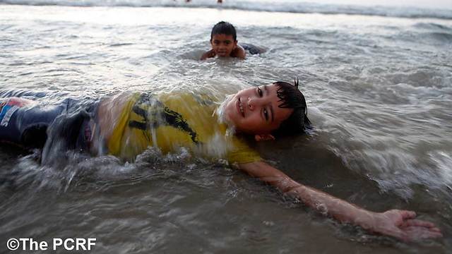 Palestinian boys play in the sea off the coast at Gaza City (Photo: Eloise Bollack/PCRF)