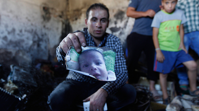 A photo of Ali Dawabsheh at the burnt house (Photo: AP)