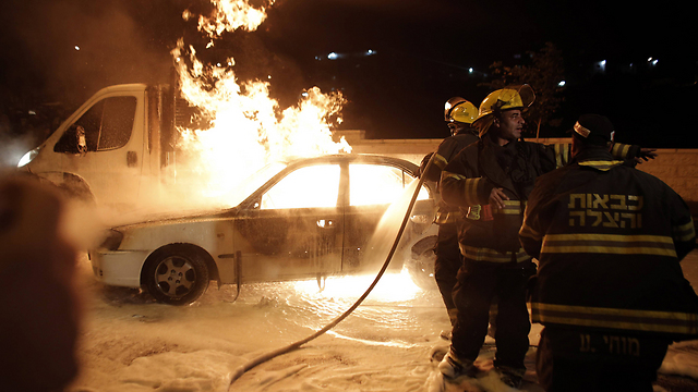 Israeli car burning after being hit by a Molotov cocktail (Photo: AFP)