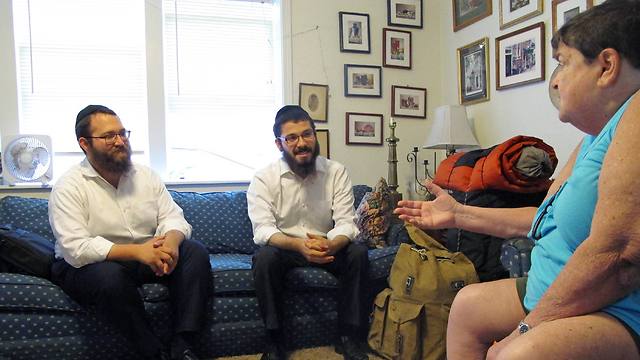 Dovid Lepkivker and Eli Chaikin listen as Beth Pagel talks about being Jewish in Montana (Photo: AP)