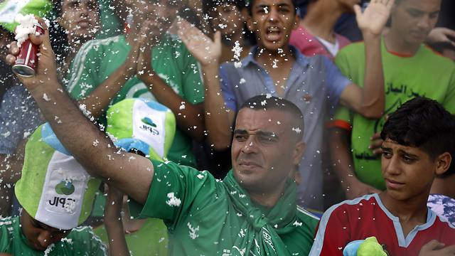 Palestinian spectators cheer during the match (Photo: AFP)
