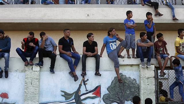 Palestinian spectators watch the first leg of Palestine Cup final soccer match (Photo: Reuters)