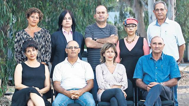 Parents of the wounded. Top row, right to left: Itzik and Edna Ozari, A.G., Lisa Kaplan, and Lisa. Seated, right to left: Yisrael and Ariela Ronen, and Kobi and Michal Magni (Photo: Dana Kopel)
