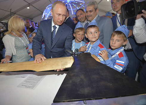 נשיא רוסיה ולדימיר פוטין מביט ביצירה "הגרזן המעופף" בפסטיבל ילדים שנערך בסלון התעופה וחלל בזוקובסקי, מחוץ למוסקבה (צילום: רויטרס) (צילום: רויטרס)