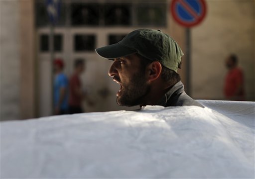 A Lebanese anti-government protester shouts slogans during a demonstration  (Photo: AP)