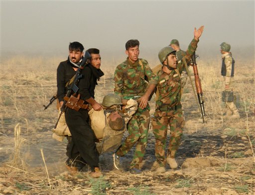 An injured Kurdish officer is taken for treatment during a military operation to regain control of some villages from Islamic State group fighters south of oil-rich city of Kirkuk (Photo: AP)