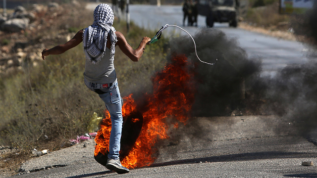 Palestinian rioter from Jalazone (Photo: AFP)