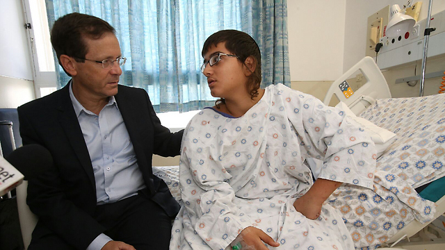 Opposition Leader Isaac Herzog visits a wounded victim of an attack in Jerusalem on Sunday. (Photo: Shaul Golan)