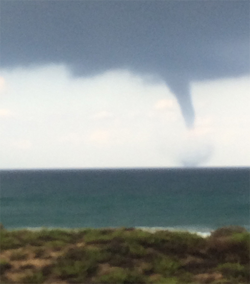 A "mini tornado" is seen along the coast. (Photo: Ophir Ohayon)