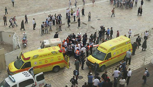 The victim and attacker being loaded onto ambulances (Photo: Magen David Adom)