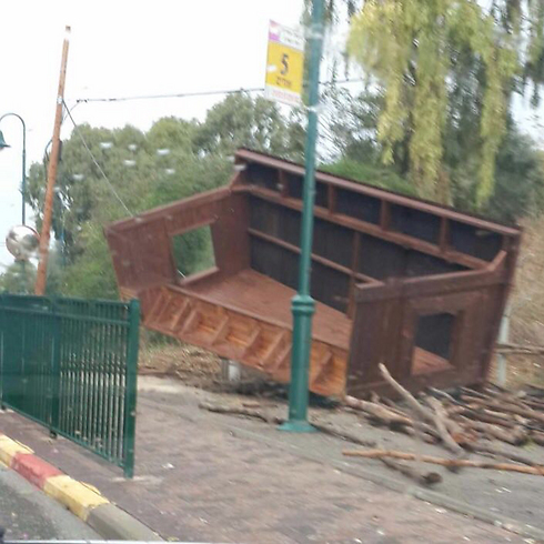 An overturned bus stop in Moshav Udim - the result of heavy winds.