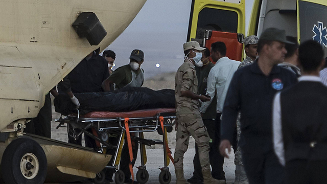 מעלים את גופות הנספים על מסוק צבאי  (צילום: AFP) (צילום: AFP)