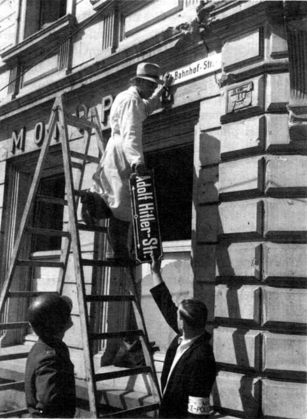 Removing a sign for Adolf Hitler Street after the war