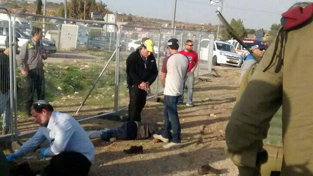 On the left: Treating the wounded victim, on the right: Guns-drawn pointed at the terrorist (Photo: Elisaf Hillela)
