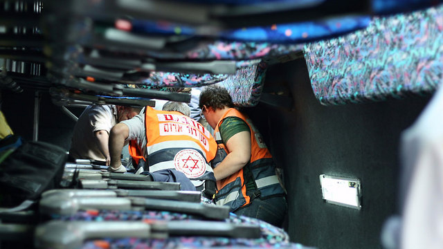 Rescuers search the bus for victims (Photo: Michal Shrak, TPS)
