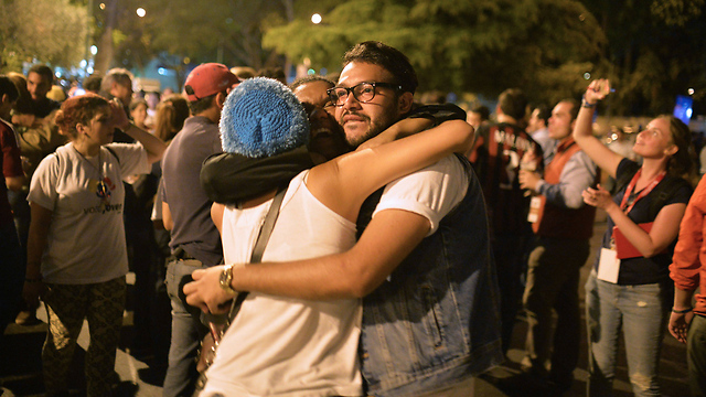 People hug in the streets after the vote (Photo: AFP)