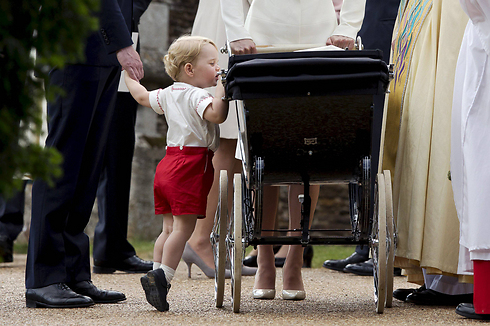 הנסיך הבריטי ג'ורג' מציץ על עגלתה של אחותו, שרלוט (צילום: רויטרס) (צילום: רויטרס)