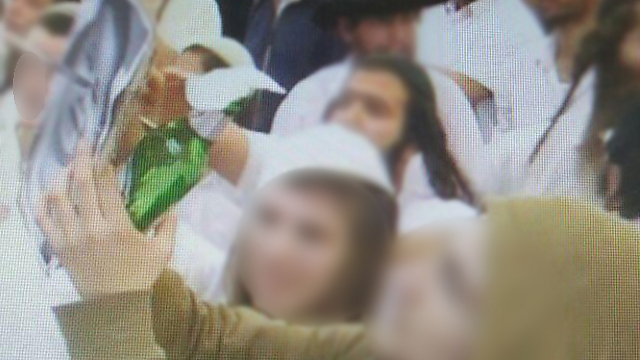 Stabbing a picture of  Ali Dawabsheh, from the wedding video.