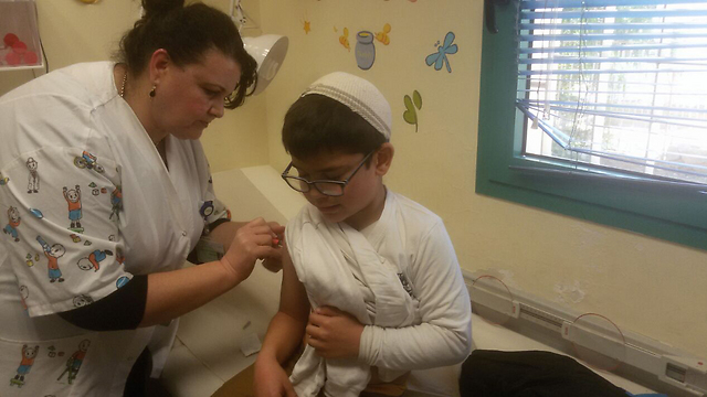 Receiving a vaccine (Photo: Amir Alon)