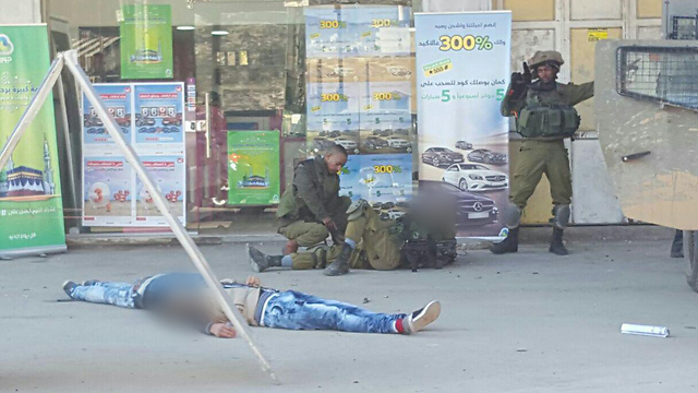 The scene of the attack Huwara, with the two neutralized terrorists and one of the soldiers on the ground (Photo: Zachariya Sada)