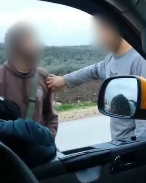 Still from video showing settlers attacking Palestinian taxi driver near Barta'a