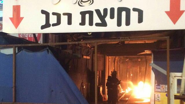 Price tag? A carwash in Petah Tikva was set on fire with anti-Arab graffiti sprayed on the wall (Photo: Fire Department and Hatzalah Petah Tikva)