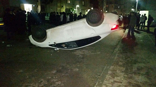 Military police vehicle overturned by ultra-Orthodox rioters in Ashdod