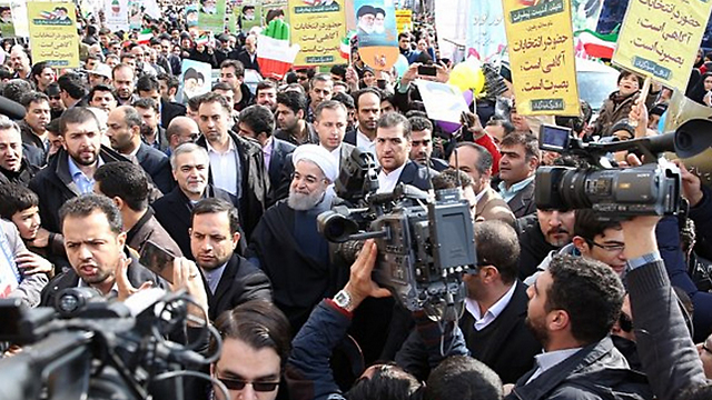 President Rouhani (center, in turban) in a crowd