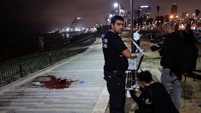 Pool of blood on the Jaffa boardwalk (Photo: AFP)