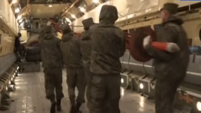 Russian forces loading equipment as they leave Syria