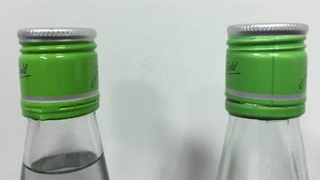 Fake bottle has vertical dark green line on cap, real bottle has no line. (Photo: Ministry of Health)